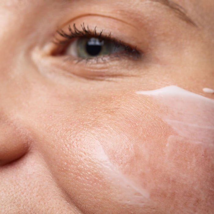 woman applying moisturizer