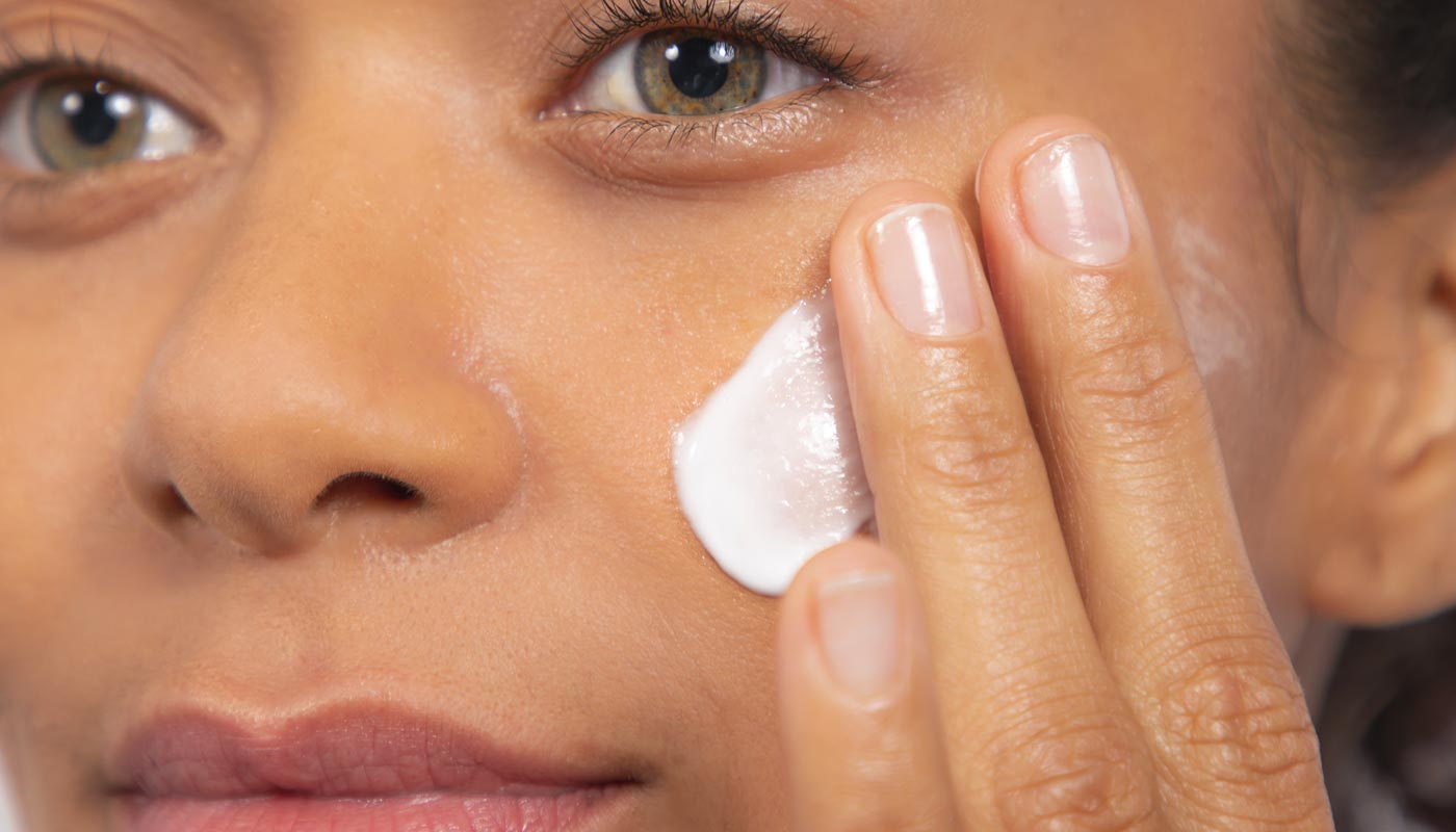 woman applying moisturizer